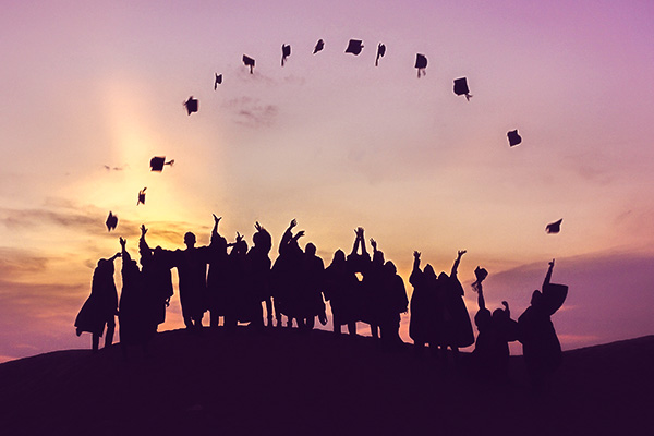 graduates tossing hats