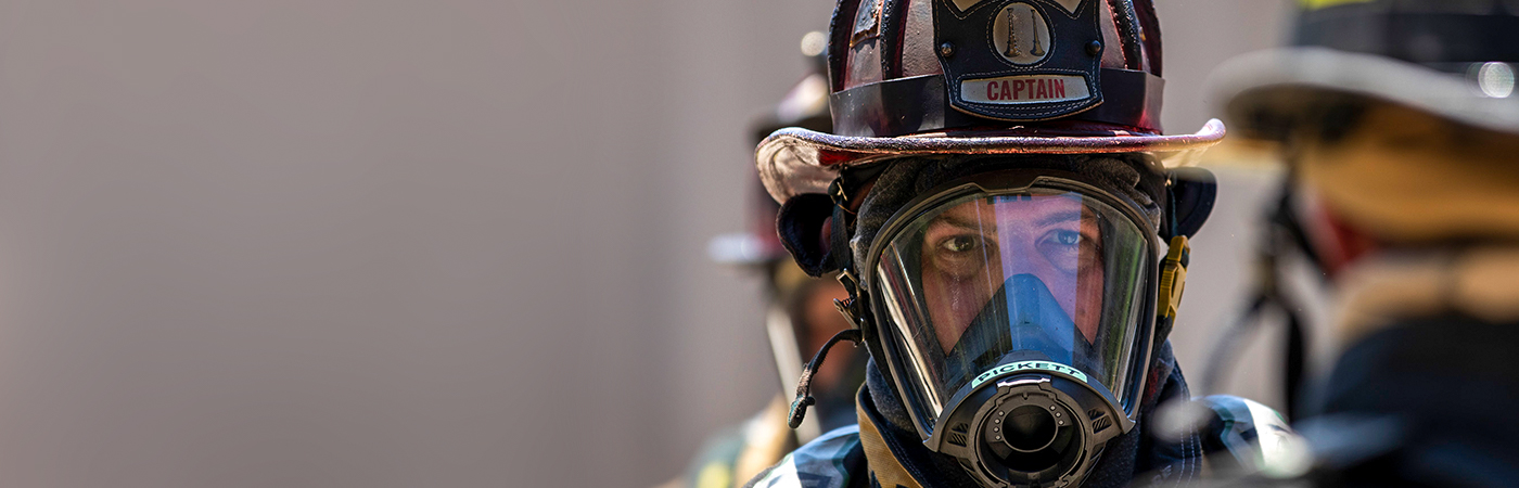 firefighter in helmet with oxygen mask